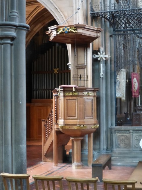 The present pulpit of light oak with gilded cherubs' heads around the base